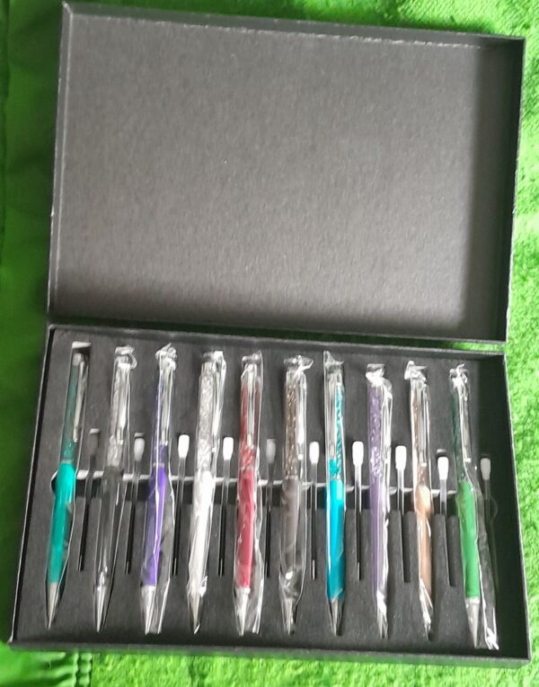 10 x glitter top propelling pen boxed set with spare refills box has storage marks